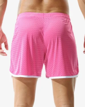 model wearing pink retro mesh shorts