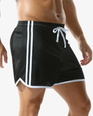 model wearing wholesale black strip mesh gay shorts
