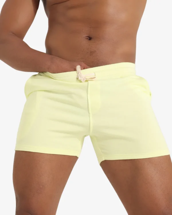 Model wearing wholesale men's pastel yellow cotton sport shorts